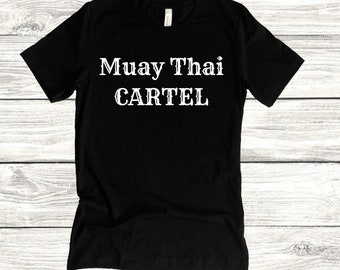 May include: Black t-shirt with white text that reads "Muay Thai Cartel"