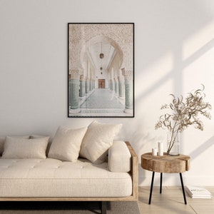 May include: A black and white photograph of a hallway with arched doorways and tiled floors. The hallway is lined with columns and the light shines through the arches.