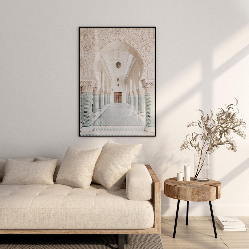 May include: A black and white photograph of a hallway with arched doorways and tiled floors. The hallway is lined with columns and the light shines through the arches.