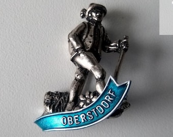 Oberstdorf brooch – 3D hiker figure with base and floral details – alpine collector piece