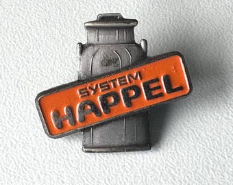 SYSTEM HAPPEL promo pin – embossed metal milk‑can symbol, 1990s