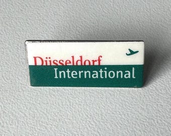 Düsseldorf International pin – rare airport souvenir with airplane motif