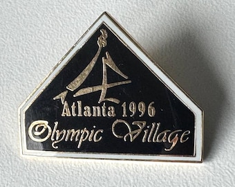 Atlanta 1996 Olympic Village pin – house‑shaped logo, ® AMI NCO