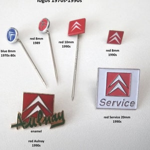 May include: A collection of vintage Citroen car logo pins. The pins are red, blue, and white enamel and feature the iconic double chevron logo. The pins are in various sizes and date from the 1970s to the 1990s.