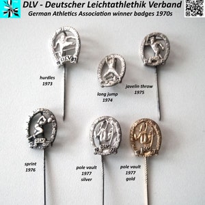 Könnte beinhalten: Eine Sammlung von sieben silbernen und goldenen Sportnadeln mit verschiedenen Sportfiguren. Die Nadeln befinden sich auf einem weißen Hintergrund. Die Nadeln stammen vom Deutschen Leichtathletik-Verband und stammen aus den 1970er Jahren. Die dargestellten Sportarten sind Hürdenlauf, Weitsprung, Speerwurf, Sprint und Stabhochsprung.