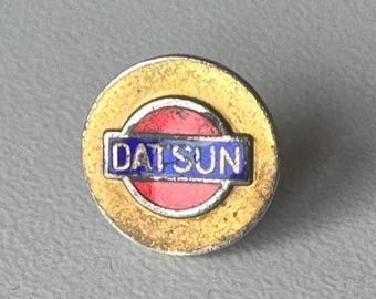 Original DATSUN logo pin – rare enamel brand collectible in silver and gold
