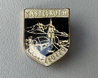 Kastelruth – Rare black‑gold crest souvenir pin with alpine line art, collector piece