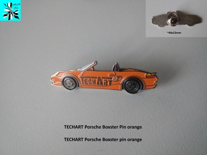 May include: Orange Porsche Boxster car pin with the word "TECHART" printed on the side. The pin is approximately 44mm x 13mm.