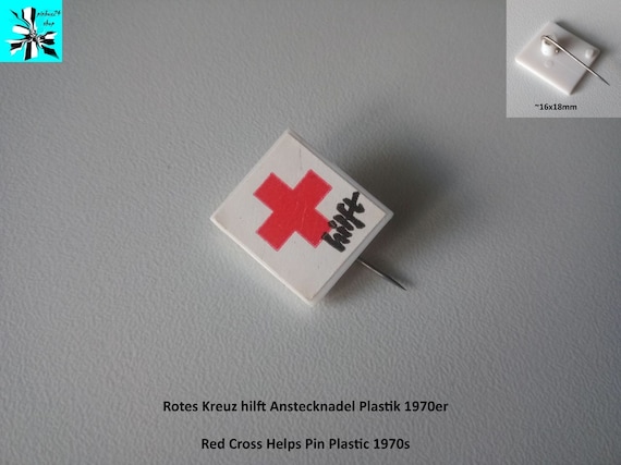 Red Cross helps: plastic pin 1970s