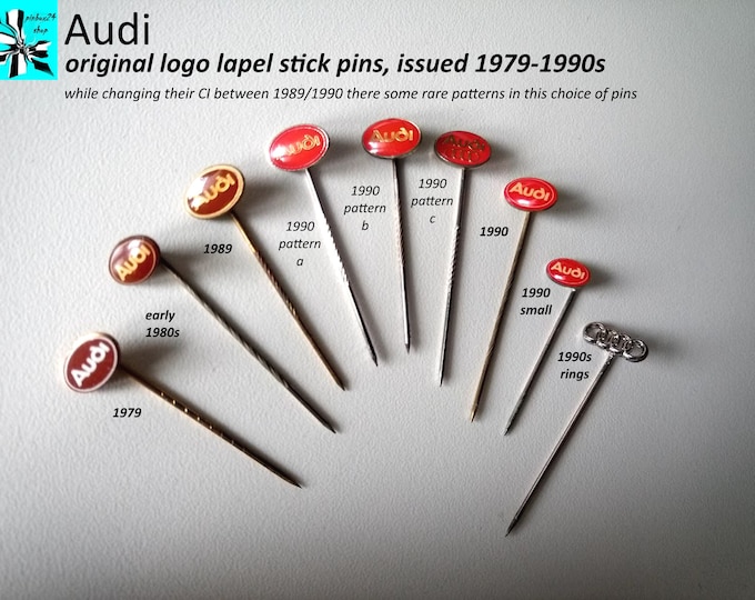 Featured listing image: Audi CI transition 1979–1990 – original lapel pins from brown to red, documented CI variants
