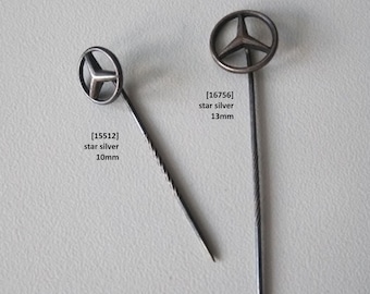 The vintage Mercedes-Benz star lapel pin is a symbol of 1950s elegance.