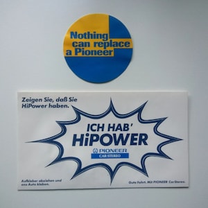 May include: A blue and yellow round sticker with the text "Nothing can replace a Pioneer". A white sticker with a blue starburst shape and the text "ICH HAB' HiPower" with the Pioneer logo and the text "Car Stereo".