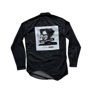 May include: Black long-sleeved button-down shirt with a white graphic print of a person wearing sunglasses and the text "Deprogrammer" and "LEGENDA TOKYO".