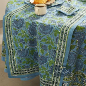 May include: Blue and green floral tablecloth with a white border. The tablecloth has a traditional Indian block print design. The tablecloth is made of cotton and is perfect for everyday use.