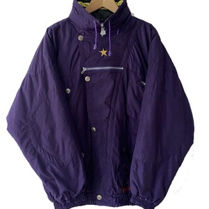 May include: A purple ski jacket with a yellow and green lining, a gold star, and a zipper closure.