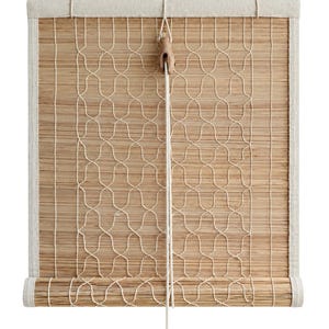May include: A bamboo roller shade featuring a natural light brown finish with a cream-colored fabric border. The shade is overlaid with a decorative cream rope netting pattern and includes a wooden pulley mechanism with a hanging white cord.