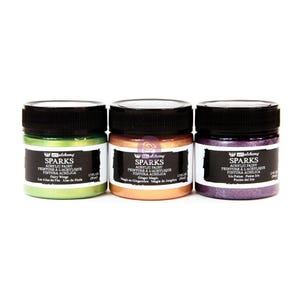 May include: Three 2 oz bottles of Art Alchemy Sparks acrylic paint. The bottles are labeled with the names "Fairy Wings", "Ginger Magic", and "Iris Potion". The paint colors are green, gold, and purple.