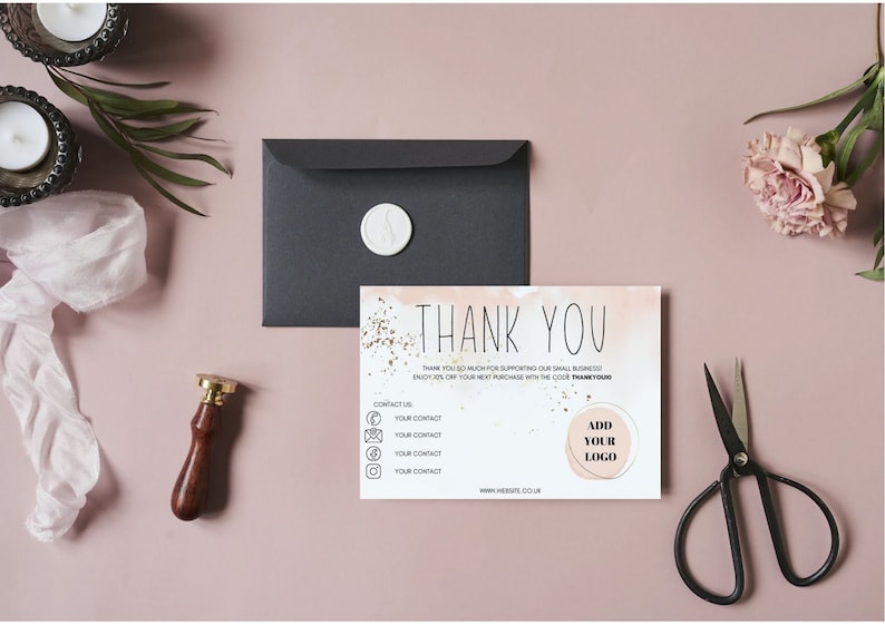 May include: A rectangular thank you card with a watercolor wash, gold foil accents, and the text THANK YOU. The card includes placeholders for contact information and a logo. A black envelope with a white wax seal, a stamp, and scissors are present.