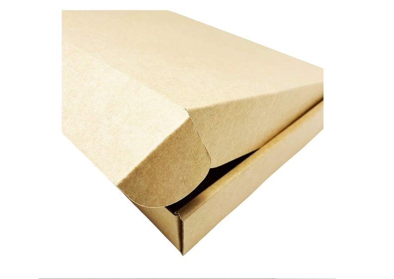 May include: A rectangular shipping box made of light brown cardboard. The box features a hinged lid with a fold-over flap design that tucks into the front edge. The surface has a matte, textured finish consistent with standard corrugated paper material.
