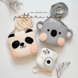 May include: Two crocheted animal-shaped purses, one panda and one koala, with a white instant camera and a sprig of dried flowers. The purses have a strap and are made with white, gray, and pink yarn. The text "PDF DOWNLOAD pattern only" is visible in the image.