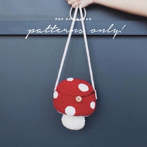 May include: A red and white crocheted mushroom-shaped bag with a white strap. The bag has white polka dots and a brown button. The text "PDF DOWNLOAD patterns only!" is visible above the bag.