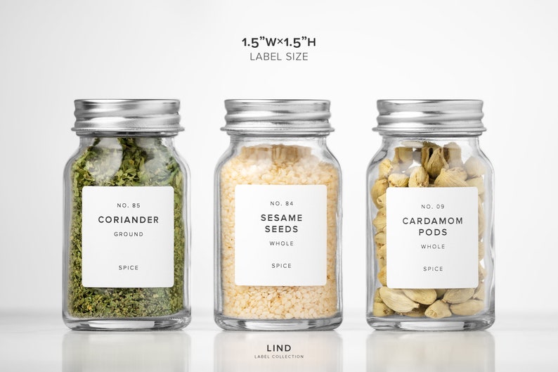 May include: Three glass spice jars with silver lids, each containing different spices. The jars are labeled with the spice name and type: coriander, sesame seeds, and cardamom pods. The label size is 1.5"W x 1.5"H.