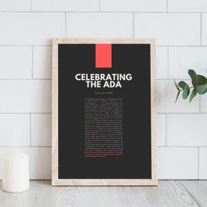 May include: A framed print with the text "CELEBRATING THE ADA" in white on a black background, with a red rectangle at the top. The print includes text about the Americans with Disabilities Act.