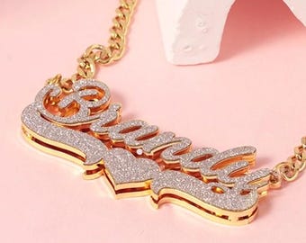 May include: Gold necklace with a sparkly nameplate that says "Brandy".
