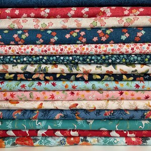 May include: A collection of patterned fabrics stacked together. The fabrics display floral, butterfly, and koi fish patterns in shades of red, blue, pink, and green. These fabrics are likely made of cotton or a similar material, ideal for quilting or craft projects.