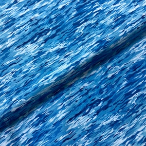 May include: Blue and white fabric with a wavy, abstract pattern reminiscent of water. The fabric has a soft, flowing texture.