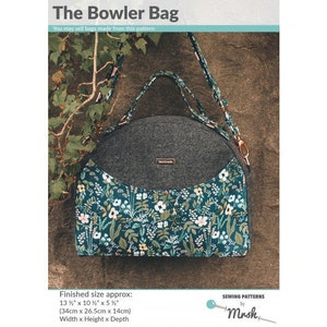 May include: A grey and teal fabric bowler bag with a floral print. The bag is 13 1/2 inches wide, 10 1/2 inches tall, and 5 1/2 inches deep. The bag has a top handle and a long strap.