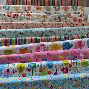 May include: A selection of patterned fabric rolls in various designs. Patterns include elephants, houses, butterflies, trees, and stripes. The fabrics are in shades of blue, pink, orange, green, and brown.