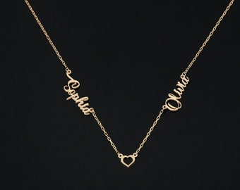 May include: Gold necklace with two names, "Sophia" and "Olivia", separated by a heart charm.
