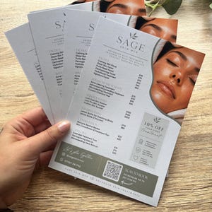 May include: A stack of white printed flyers for Sage Skin MCR featuring a list of facial and advanced skin treatments, pricing in pounds, a 10% off promotional box, a QR code, and a photograph of a person with glowing skin on the right side.