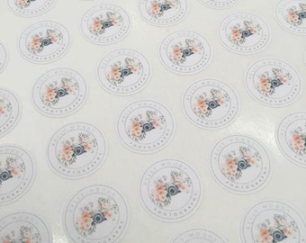 May include: A sheet of round stickers with a floral design and the text "Kelly Moody Photography" in a gray font.