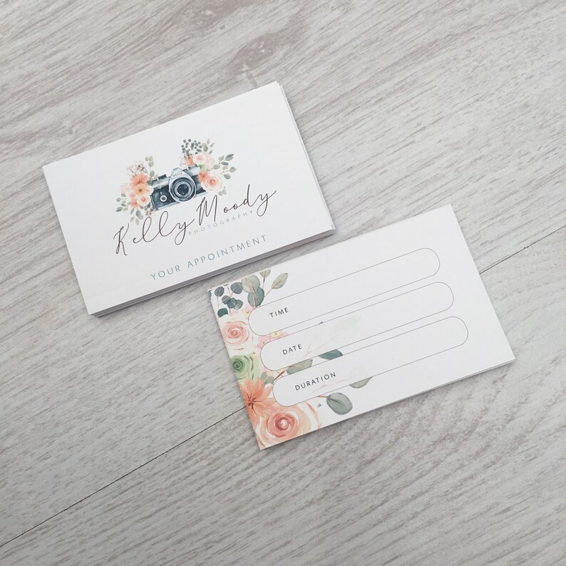 May include: A white appointment card with a floral design and the text "Kelly Moody Photography" and "Your Appointment". The card has blank lines for time, date, and duration.