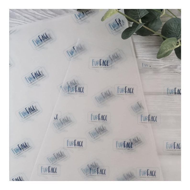 May include: White tissue paper sheets with a repeating pattern of the text "FURFACE" in a light blue speech bubble design. The paper is semi-transparent, and the design is visible on both sides. The paper is likely for handmade dog supplies.