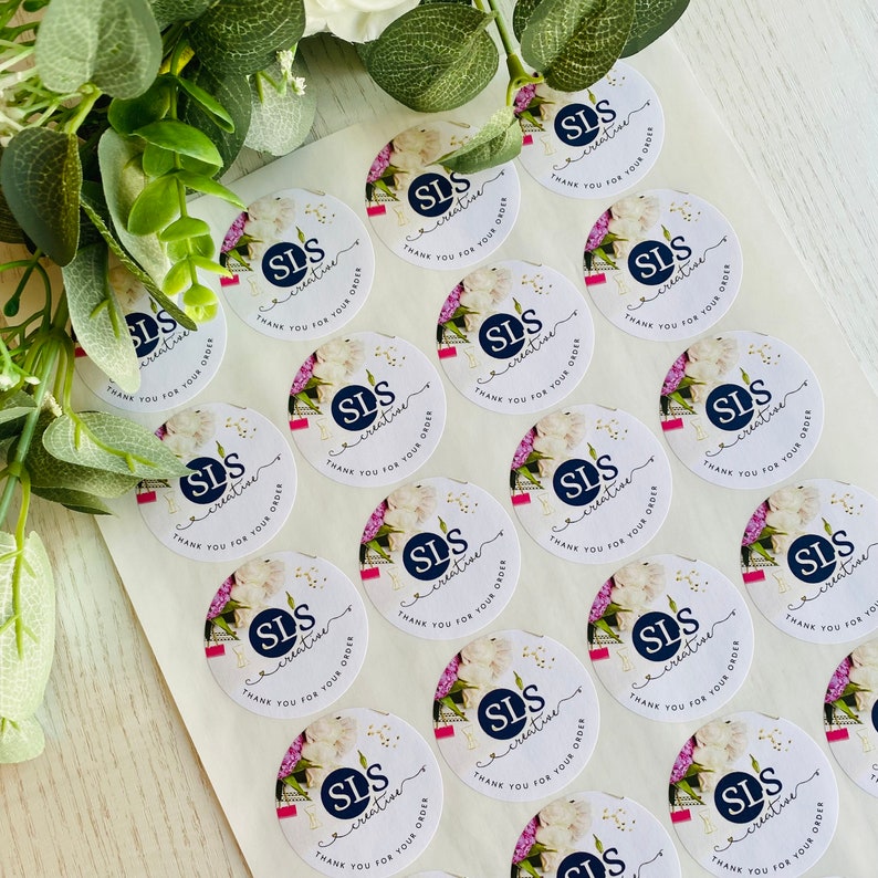 May include: A sheet of white round stickers with a floral design and the text "SLS creative" and "Thank you for your order".