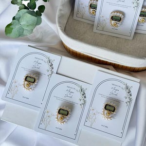 Personalized Islamic wedding favor featuring a digital tasbih counter attached to a custom Nikkah card with couple names and wedding date, elegant Muslim wedding guest gift display with floral design.