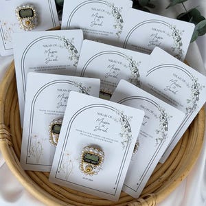 Custom Nikkah favor with digital prayer counter, personalized Muslim wedding keepsake featuring floral artwork, couple names, and wedding date for guests.