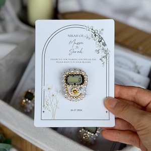 Custom Nikkah favor with digital prayer counter, personalized Muslim wedding keepsake featuring floral artwork, couple names, and wedding date for guests.