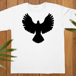 May include: A white short-sleeved t-shirt featuring a solid black silhouette of a bird with its wings spread wide in flight centered on the chest. The garment has a classic crew neckline and a straight hemline, providing a clean and simple look.