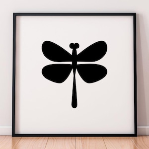 May include: A framed art print featuring a minimalist black dragonfly silhouette against a white background. The dragonfly has four rounded wings and a long, slender body. The artwork is displayed in a black frame.