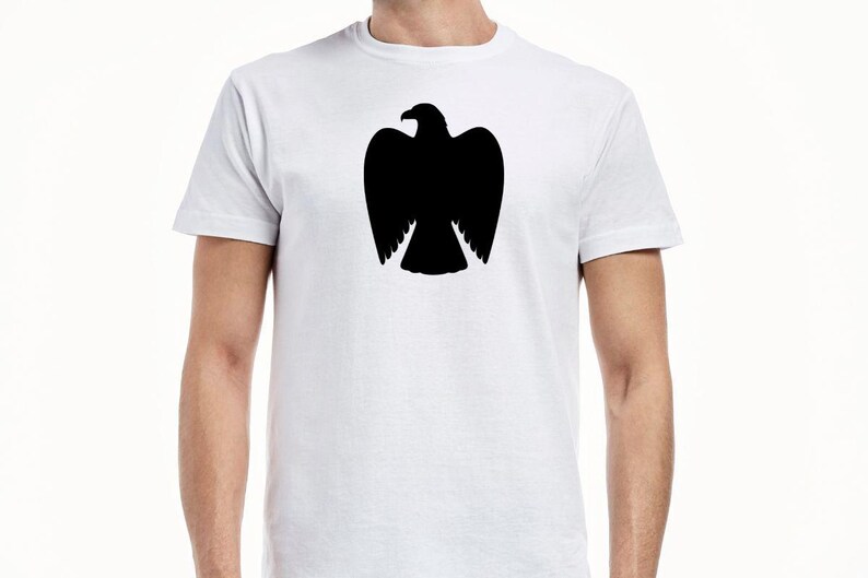 May include: A white short-sleeved t-shirt featuring a solid black silhouette of an eagle with its wings tucked in, centered on the chest. The garment has a crew neckline and a standard fit, providing a clean contrast between the dark graphic and fabric.