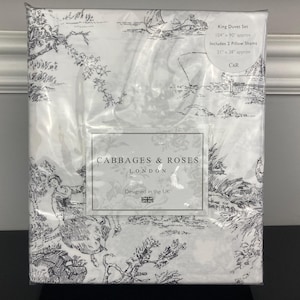 May include: A King Duvet Set by Cabbages & Roses, featuring a black and white toile pattern. The set includes two pillow shams. The duvet cover measures approximately 104" x 90". The pillow shams are approximately 21" x 38". Designed in the UK.
