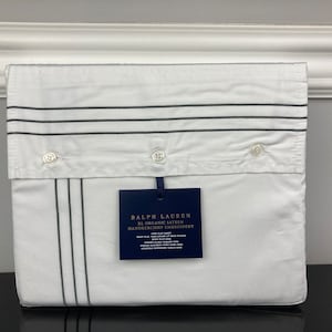 May include: White cotton bed sheet with gray stripes and a blue label that reads "Ralph Lauren RL Organic Satin Handkerchief Embroidery".