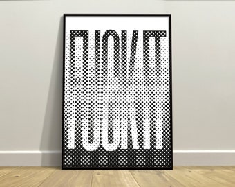 May include: Black framed art print with the word "FUCK IT" in large white letters. The letters are created using a halftone dot pattern, transitioning from solid white to black. The artwork is displayed on a white wall above a wooden floor.