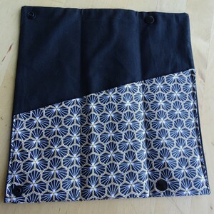 May include: Black fabric pouch with three compartments, lined with a white and gold geometric pattern.