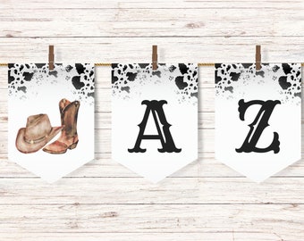 May include: A banner with three white pennants hanging from a string. The left pennant features a watercolor illustration of a cowboy hat and boots. The middle and right pennants display the letters "A" and "Z" in black, with a cow print design at the top.
