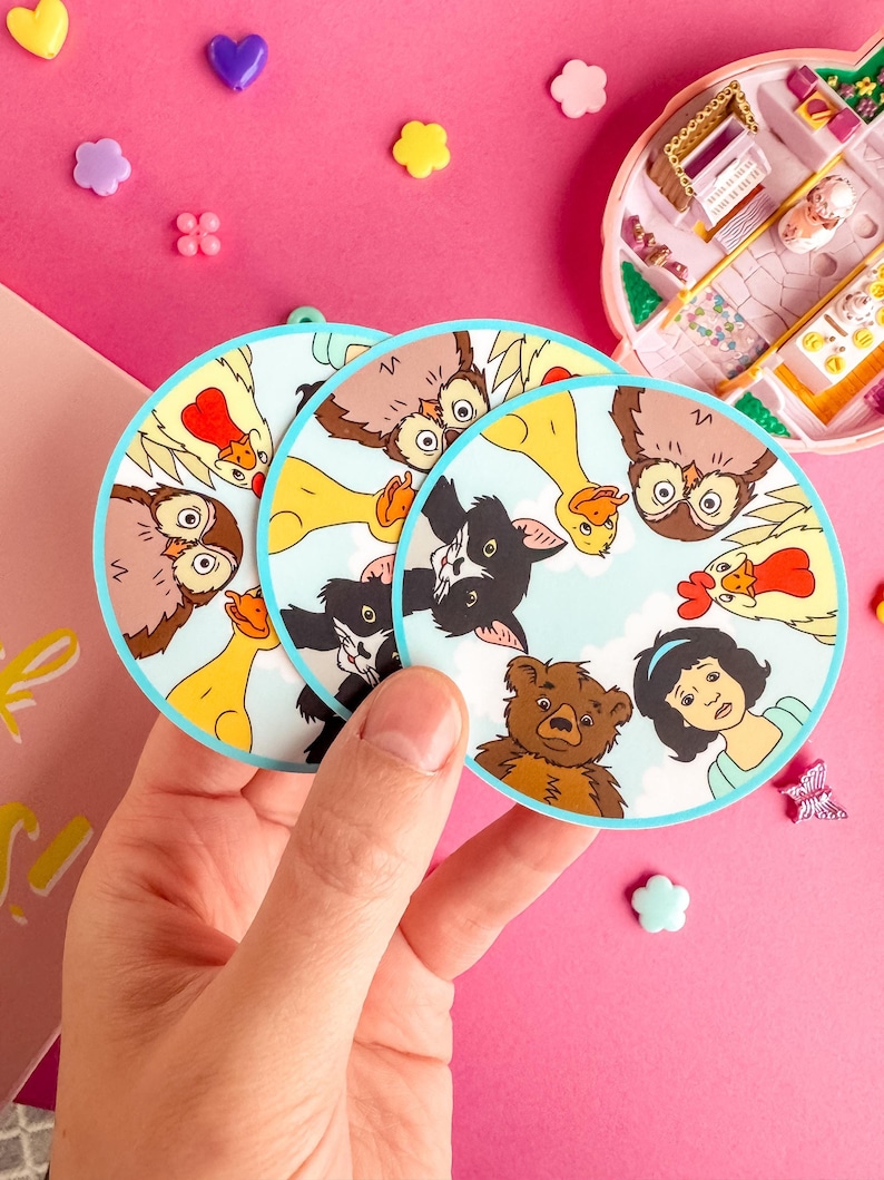 Puede incluir: Tres pegatinas circulares con un fondo de cielo azul claro e ilustraciones de un b&uacute;ho marr&oacute;n, un pato amarillo, un gato blanco y negro, un gallo con cresta roja, un oso pardo y una persona de pelo oscuro, dispuestos en un patr&oacute;n circular.